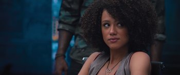 Movie still from “The Fate of the Furious” (2017), directed by F. Gary Gray – A woman that is looking at the camera; Close Up shot, Over the shoulder angle