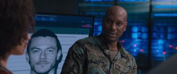 Movie still from “The Fate of the Furious” (2017), directed by F. Gary Gray – A man standing in front of a computer screen; Close Up shot, Over the shoulder angle