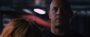 Movie still from “The Fate of the Furious” (2017), directed by F. Gary Gray – A man with a bald head looking into the distance; Close Up shot, Over the shoulder angle