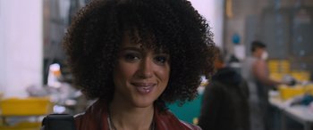Movie still from “The Fate of the Furious” (2017), directed by F. Gary Gray – A person with curly hair smiling; Close Up shot, Over the shoulder angle