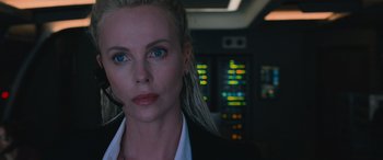 Movie still from “The Fate of the Furious” (2017), directed by F. Gary Gray – Charlize theron wearing a suit; Close Up shot, Over the shoulder angle