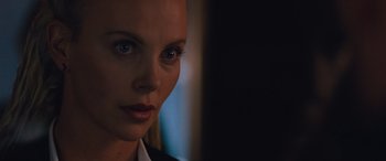 Movie still from “The Fate of the Furious” (2017), directed by F. Gary Gray – A woman's face in the dark; Close Up shot, Over the shoulder angle