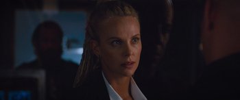 Movie still from “The Fate of the Furious” (2017), directed by F. Gary Gray – Charlize theron wearing a suit; Close Up shot, Over the shoulder angle