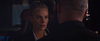 Movie still from “The Fate of the Furious” (2017), directed by F. Gary Gray – A woman is looking at a man in a suit; Close Up shot, Over the shoulder angle