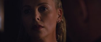 Movie still from “The Fate of the Furious” (2017), directed by F. Gary Gray – A person's face with ear piercings; Close Up shot, Over the shoulder angle