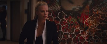 Movie still from “The Fate of the Furious” (2017), directed by F. Gary Gray – A woman wearing a black jacket and a white shirt; Close Up shot, Over the shoulder angle