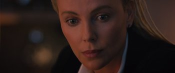 Movie still from “The Fate of the Furious” (2017), directed by F. Gary Gray – A woman's face in a white shirt; Close Up shot, Over the shoulder angle