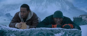 Movie still from “The Fate of the Furious” (2017), directed by F. Gary Gray – Two men laying on the ground in the snow; Medium shot, High angle