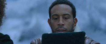 Movie still from “The Fate of the Furious” (2017), directed by F. Gary Gray – A person using a tablet device; Close Up shot, Over the shoulder angle