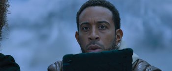 Movie still from “The Fate of the Furious” (2017), directed by F. Gary Gray – A person holding a cell phone; Close Up shot, Over the shoulder angle