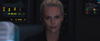 Movie still from “The Fate of the Furious” (2017), directed by F. Gary Gray – A woman wearing a headset in front of a computer screen; Close Up shot, Low angle