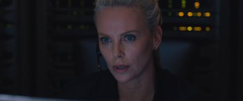 Movie still from “The Fate of the Furious” (2017), directed by F. Gary Gray – A woman wearing a headset looking at a computer screen; Close Up shot, Low angle