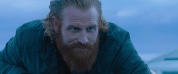 Movie still from “The Fate of the Furious” (2017), directed by F. Gary Gray – A person with long hair and a red beard; Close Up shot, Low angle