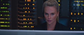 Movie still from “The Fate of the Furious” (2017), directed by F. Gary Gray – A woman sitting in front of a computer monitor; Close Up shot, Over the shoulder angle