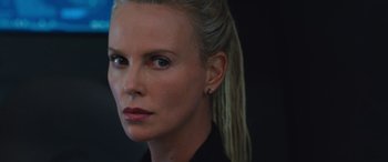 Movie still from “The Fate of the Furious” (2017), directed by F. Gary Gray – Charlize theron is looking into the camera; Close Up shot, Over the shoulder angle