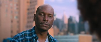 Movie still from “The Fate of the Furious” (2017), directed by F. Gary Gray – A person wearing a plaid shirt; Close Up shot, Low angle