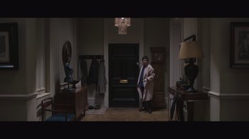 Movie still from “The Father” (2020), directed by Florian Zeller – A man standing in front of an entrance way; Wide shot, High angle
