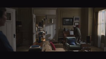 Movie still from “The Father” (2020), directed by Florian Zeller – An old man standing in a living room next to a piano; Wide shot, High angle