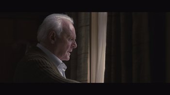 Movie still from “The Father” (2020), directed by Florian Zeller – An older man looking out of a window; Close Up shot, Over the shoulder angle