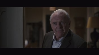 Movie still from “The Father” (2020), directed by Florian Zeller – An older man in a suit looking at the camera; Close Up shot, Over the shoulder angle