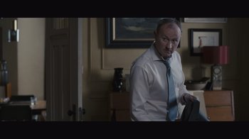 Movie still from “The Father” (2020), directed by Florian Zeller – A man in a white dress shirt and blue tie; Medium shot, Low angle