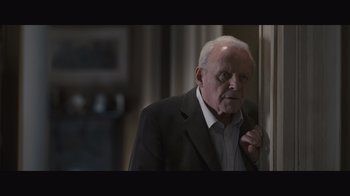 Movie still from “The Father” (2020), directed by Florian Zeller – An older man wearing a suit and tie; Medium shot, High angle