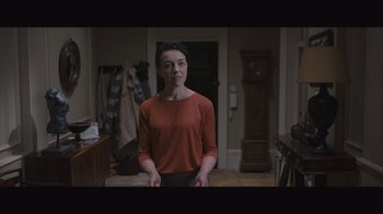 Movie still from “The Father” (2020), directed by Florian Zeller – A woman standing in a room in front of a door; Medium shot, Over the shoulder angle