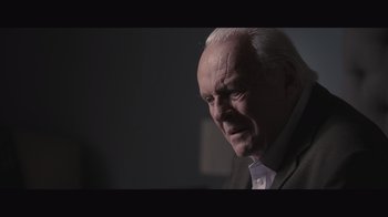 Movie still from “The Father” (2020), directed by Florian Zeller – An older man in a suit and tie looking to his left; Close Up shot, Over the shoulder angle