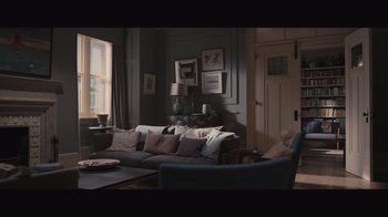 Movie still from “The Father” (2020), directed by Florian Zeller – A living room filled with furniture and pictures on the wall; Wide shot, High angle