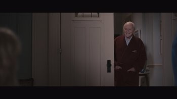 Movie still from “The Father” (2020), directed by Florian Zeller – An older man in a robe standing in front of an open door; Medium shot, High angle