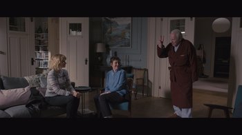 Movie still from “The Father” (2020), directed by Florian Zeller – Two women and an older man in a living room; Wide shot, Over the shoulder angle