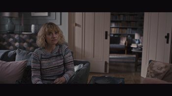 Movie still from “The Father” (2020), directed by Florian Zeller – A woman sitting in a chair in a living room; Medium shot, Over the shoulder angle