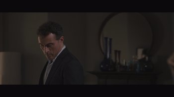 Movie still from “The Father” (2020), directed by Florian Zeller – A man wearing a suit and tie standing in a room; Medium shot, Low angle