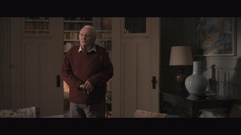 Movie still from “The Father” (2020), directed by Florian Zeller – An older man standing in front of a living room door; Medium shot, High angle