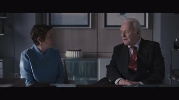 Movie still from “The Father” (2020), directed by Florian Zeller – A man and a woman sitting at a table talking to each other; Medium shot, Over the shoulder angle