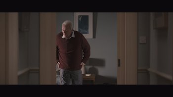 Movie still from “The Father” (2020), directed by Florian Zeller – An older man standing in a room with his hands on his hips; Medium shot, High angle