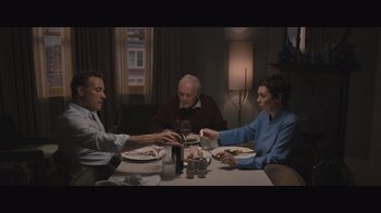 Movie still from “The Father” (2020), directed by Florian Zeller – A group of people sitting around a table eating food; Medium shot, High angle