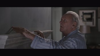 Movie still from “The Father” (2020), directed by Florian Zeller – An older man is holding his hands up; Close Up shot, Low angle