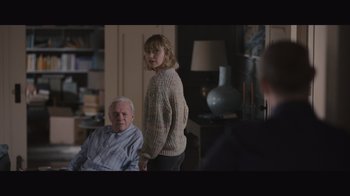 Movie still from “The Father” (2020), directed by Florian Zeller – A young girl standing next to an older man; Medium shot, Over the shoulder angle