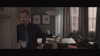 Movie still from “The Father” (2020), directed by Florian Zeller – A man standing in front of a dining room table; Medium shot, Over the shoulder angle