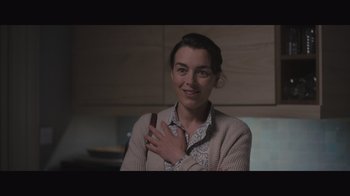 Movie still from “The Father” (2020), directed by Florian Zeller – A woman holding a cell phone in her right hand; Close Up shot, Over the shoulder angle