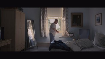 Movie still from “The Father” (2020), directed by Florian Zeller – An older man standing in front of a window; Wide shot, Low angle