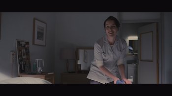 Movie still from “The Father” (2020), directed by Florian Zeller – A woman in a white shirt is standing in a room; Medium shot, Low angle
