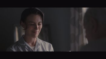 Movie still from “The Father” (2020), directed by Florian Zeller – A woman in a white lab coat is smiling; Close Up shot, Low angle