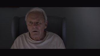 Movie still from “The Father” (2020), directed by Florian Zeller – An old man sitting in a chair with his mouth wide open; Close Up shot, High angle