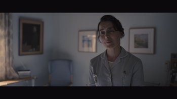Movie still from “The Father” (2020), directed by Florian Zeller – A woman in a room with a chair in the background; Close Up shot, Low angle