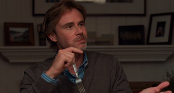 Movie still from “The Fault in Our Stars” (2014), directed by Josh Boone – A man holding a fork in his hand while sitting in a room; Close Up shot, Over the shoulder angle