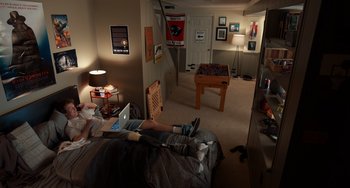 Movie still from “The Fault in Our Stars” (2014), directed by Josh Boone – A person laying on a bed in a room; Wide shot, High angle