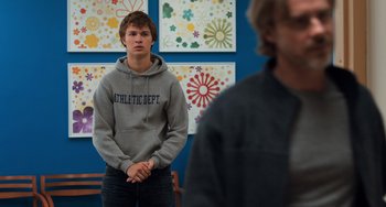 Movie still from “The Fault in Our Stars” (2014), directed by Josh Boone – A young man standing in front of a group of people; Medium shot, Over the shoulder angle