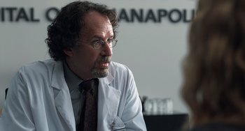 Movie still from “The Fault in Our Stars” (2014), directed by Josh Boone – A man wearing a lab coat talking to a woman; Close Up shot, Over the shoulder angle